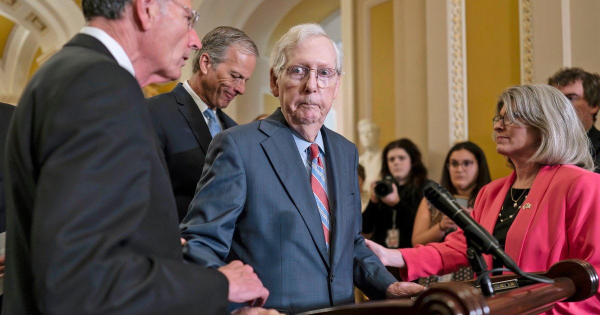Mitch McConnell escorted away from cameras after freezing during a news conference