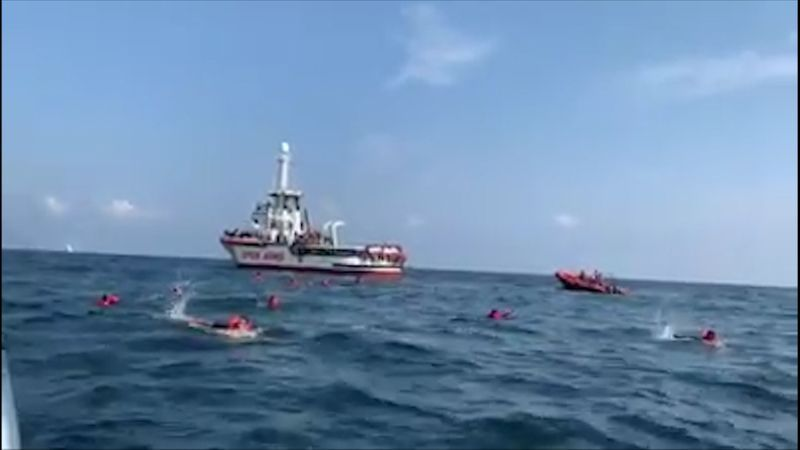 Desperate migrants jump overboard from charity boat off Italy